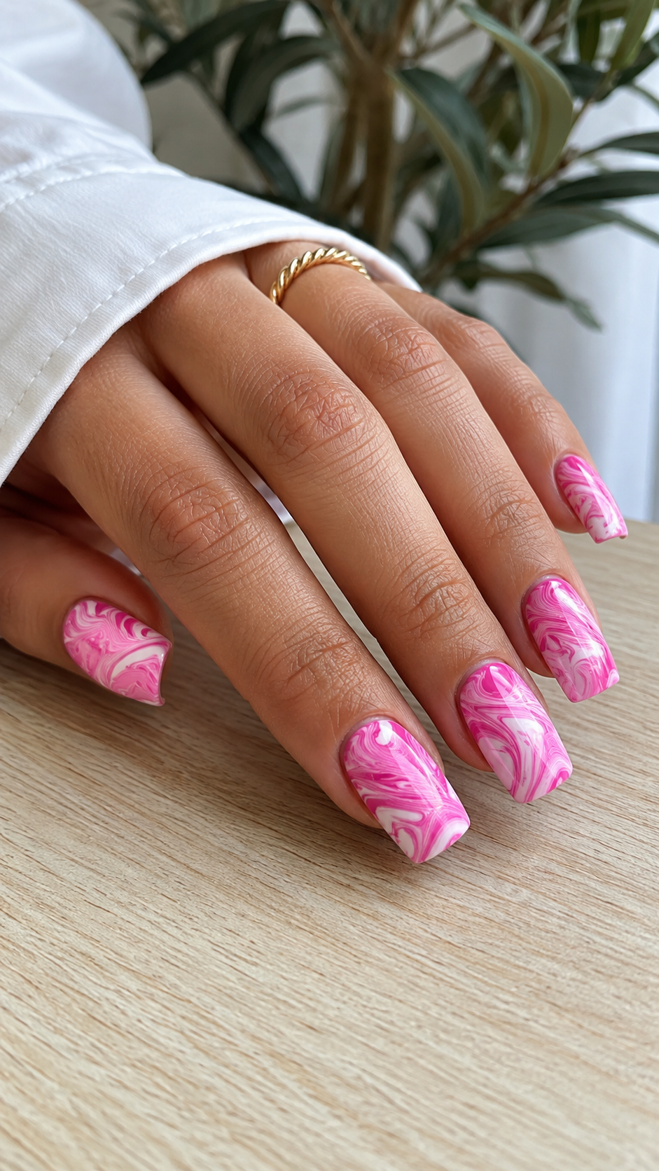 Hot pink marble swirl nail art, bright pink nails with design.