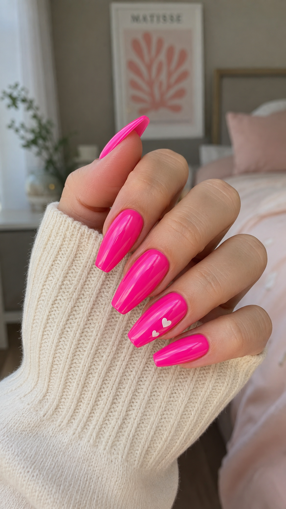 Neon hot pink nail design with tiny heart accent, cute birthday nails idea.